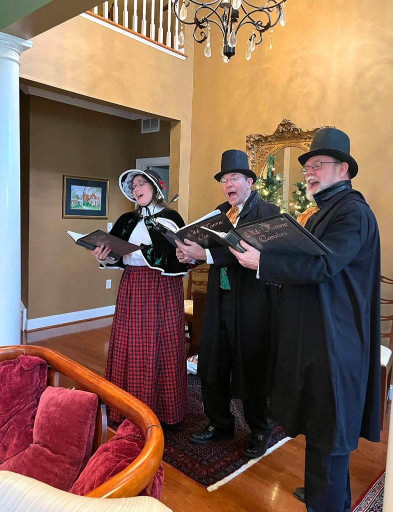 A trio of Carol-Gram singers perform in 2022.