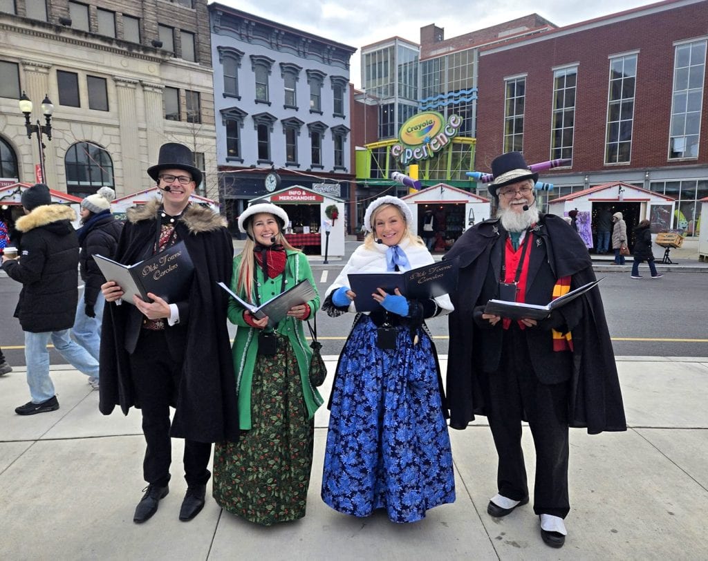 The carolers entertain passersby in front of Easton's Crayola Experience.
